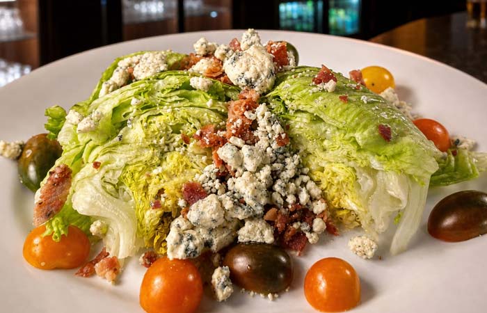 Wedge salad with iceberg lettuce, blue cheese, bacon, and tomatoes at Torey’s Restaurant & Bar.