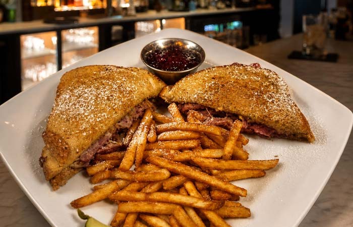 Enjoy a steak sandwich with fries and sauce at Torey’s Restaurant & Bar in Owatonna, sugar-dusted.