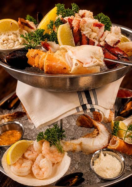 Seafood platter with shrimp, lobster, and sauces—perfect with cocktails in Owatonna.