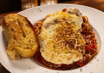 Enjoy Pasta at Torey’s Restaurant & Bar in Owatonna with marinara, cheese, and garlic bread.